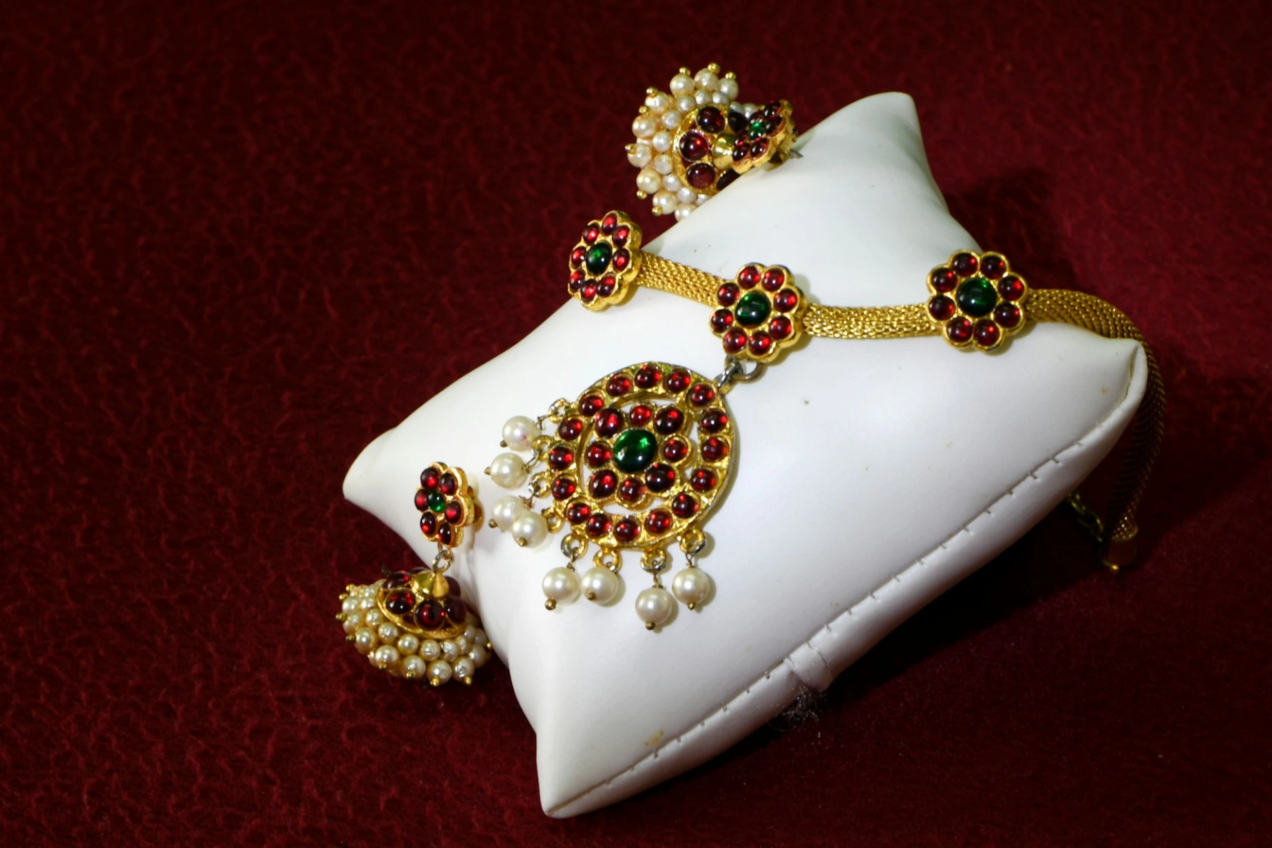 A close up of a white pillow on a red surface